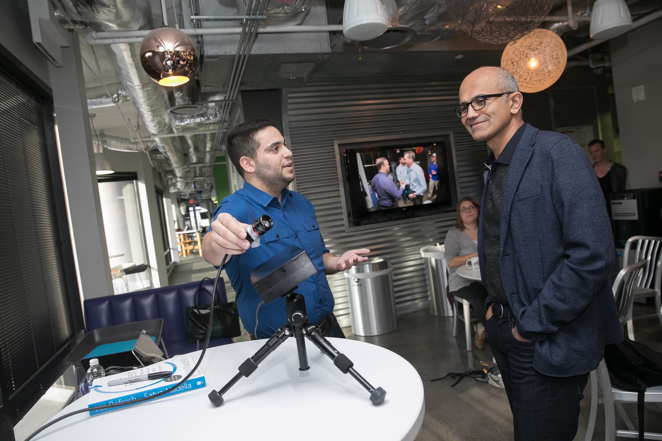 Satya Nadella watching a founder's hardware demo